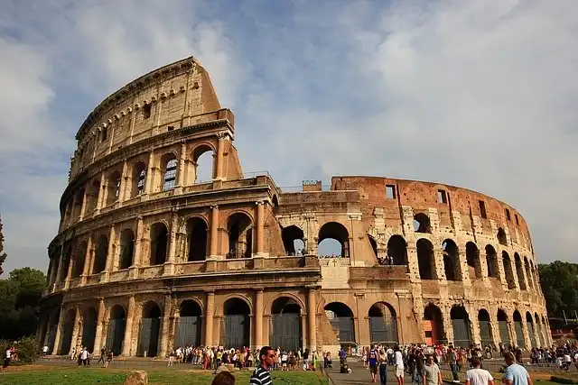 The historic Roman Colosseum in Rome, Italy, partially illuminated at night