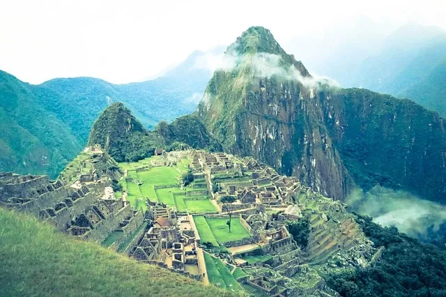 Ancient Incan city of Machu Picchu surrounded by Andes mountains in Peru